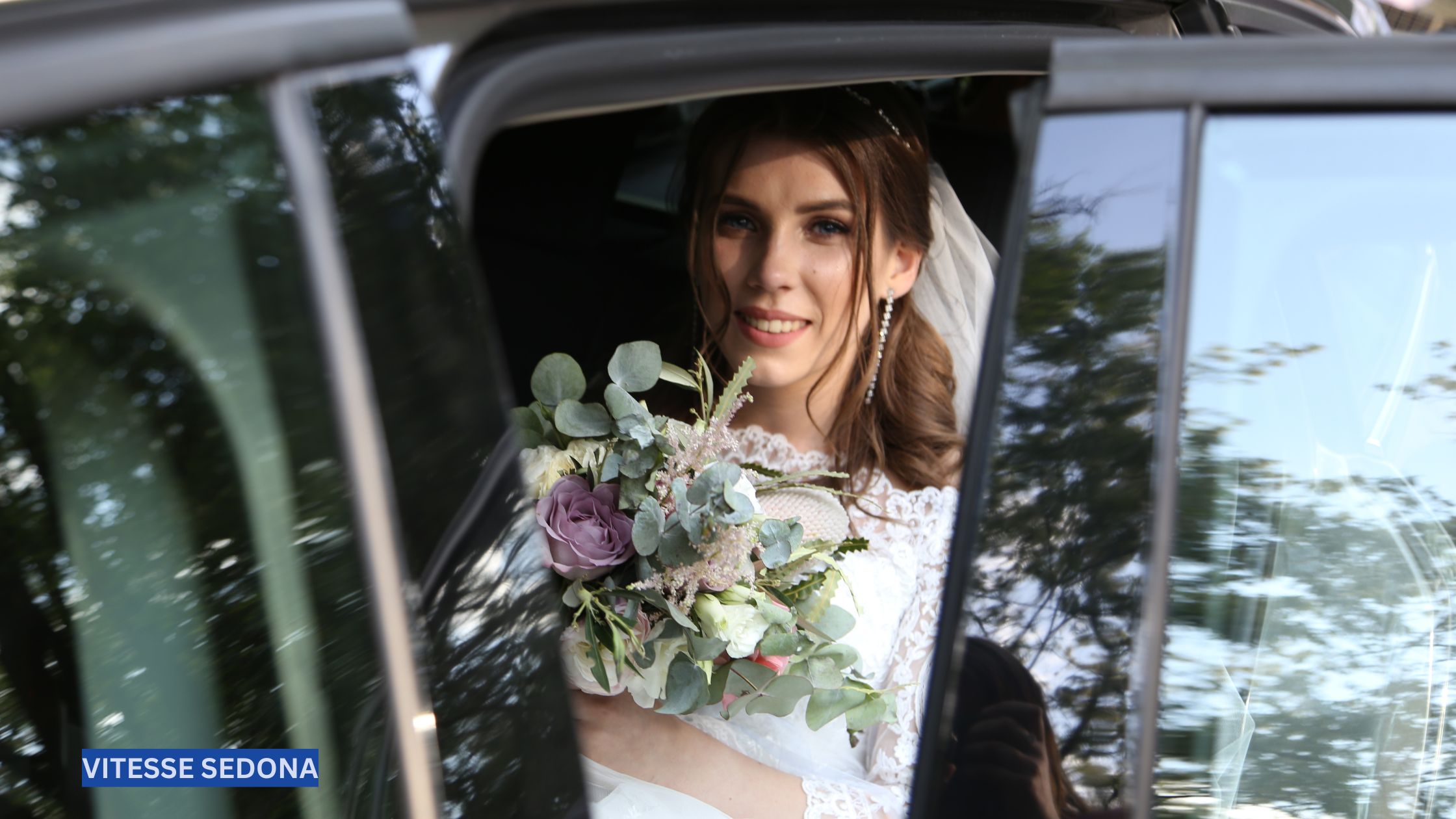 Bride smiling inside a luxury wedding limousine in Sedona