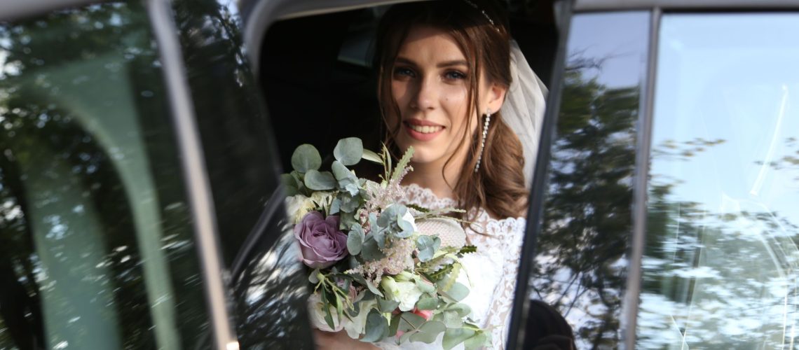 Bride smiling inside a luxury wedding limousine in Sedona